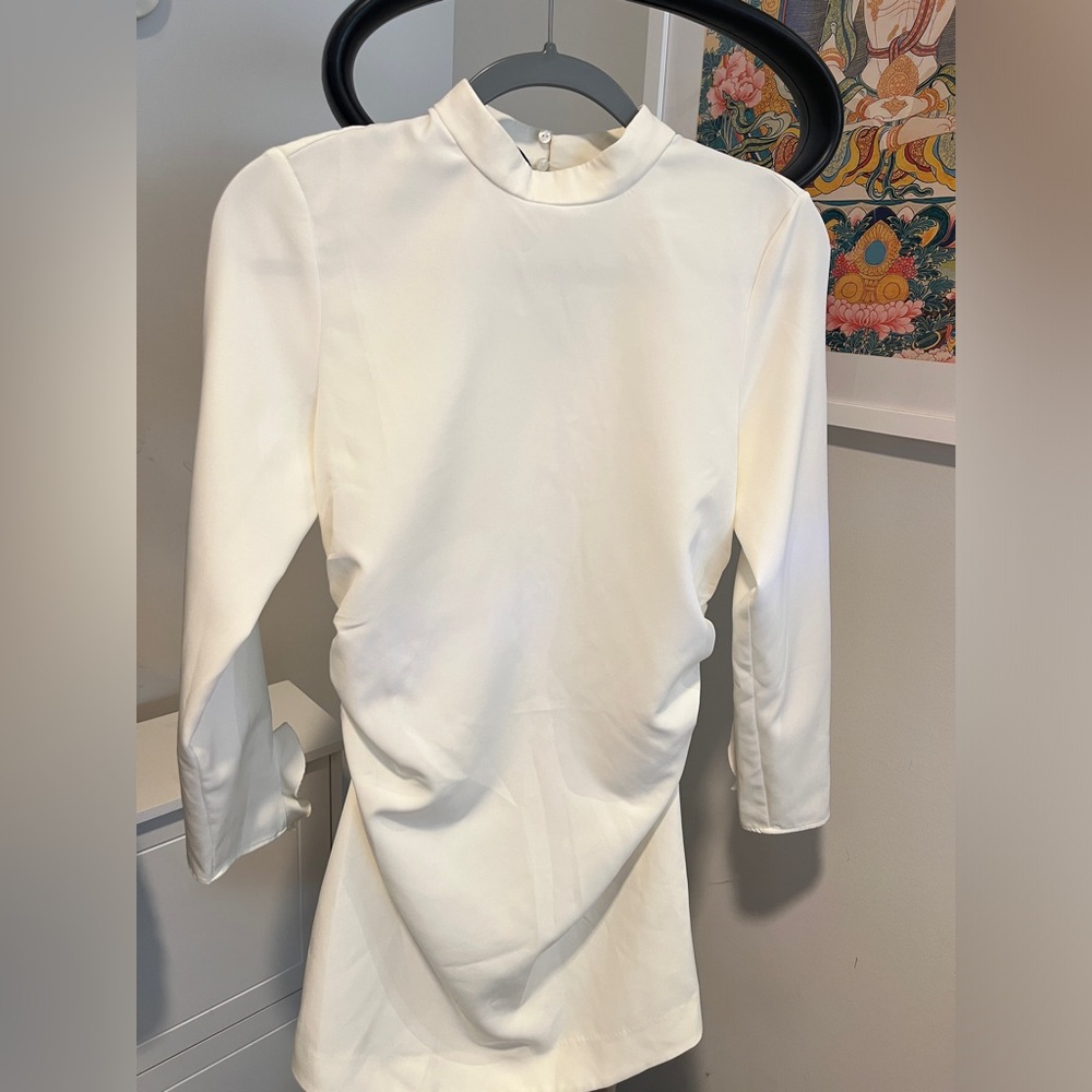 Mod and stylish ZARA white mini dress with ruffle detail at each wrist.